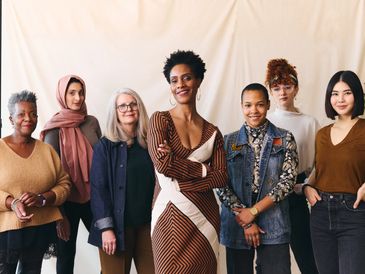 Diverse group of confident women standing together, smiling.