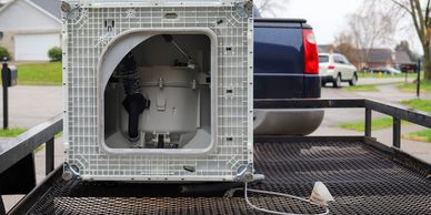 Washing machine in bed of pickup headed to the landfill