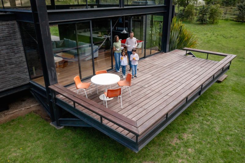 Happy Latin American family eating breakfast outdoors on the terrace and smiling - lifestyle concepts