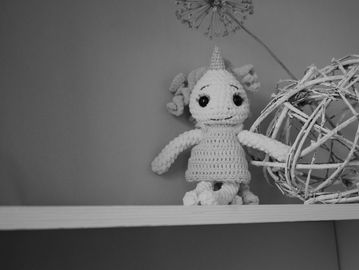crocheted doll on a shelf