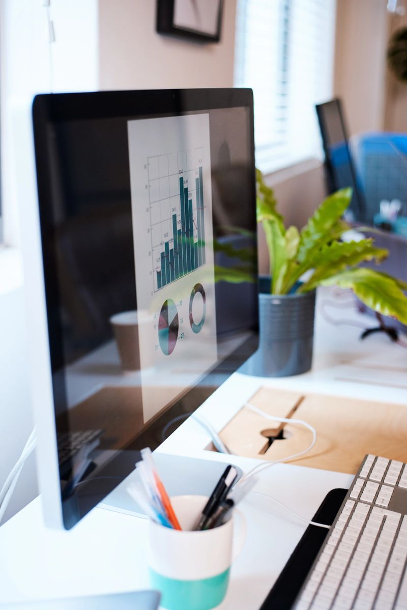 A desktop computer screen with a bar graph and pie chart in blue. High quality photo