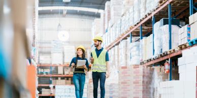 Workers inspecting inventory in a warehouse.