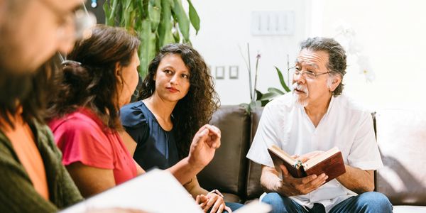 Group discussing while reading books.