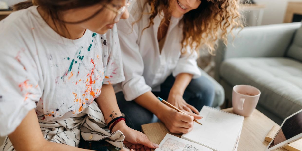 Two women collaborating on a creative project.