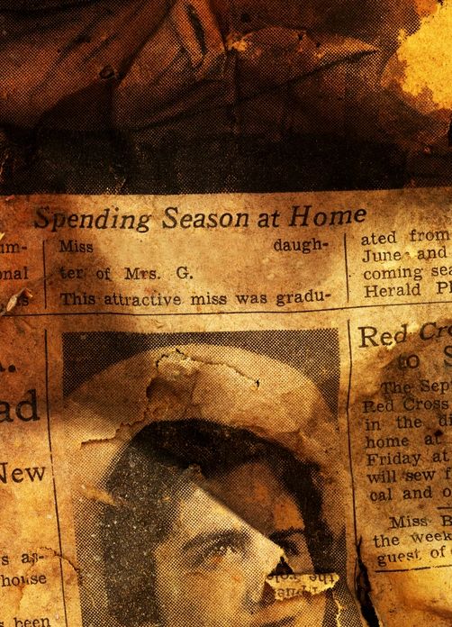 A fragment of a newsaper, texture, words, and photo are all starting to fade.