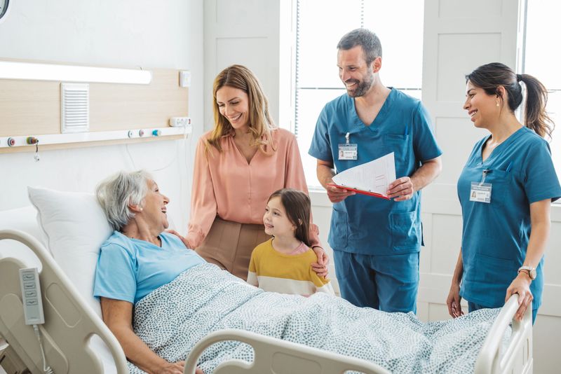 Woman with daughter visiting her mother at hospital, she is talking with doctor and showing love and care for her mother.