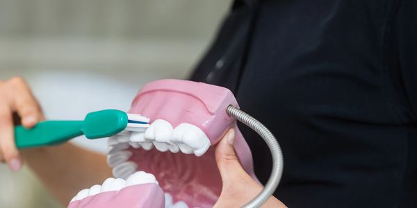 Dentist dr showing how to clean tooth