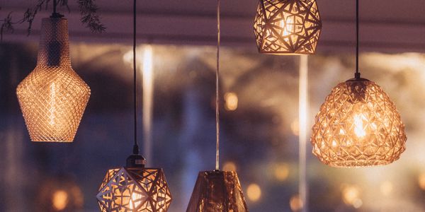 Warmly lit decorative hanging lamps with intricate designs.