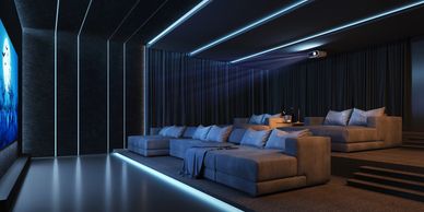 Modern home theater room with tiered seating and blue ambient lighting.
