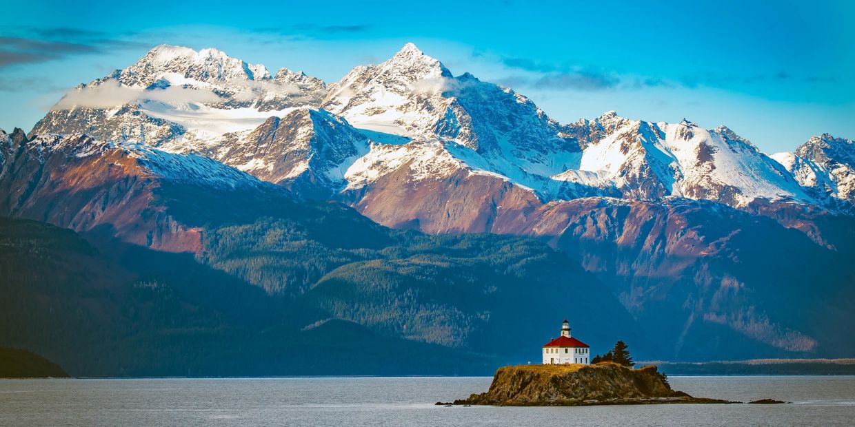 Snowy peaks and tranquil lake in Alaska.