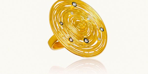 Golden ring with intricate spiral design and embedded gems.