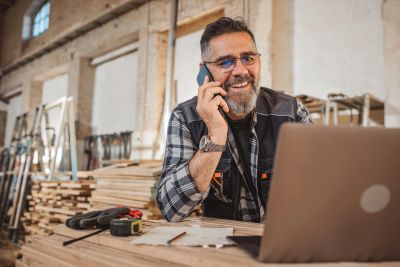 Man talking on phone in workshop.