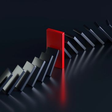 Red block stopping black dominoes.