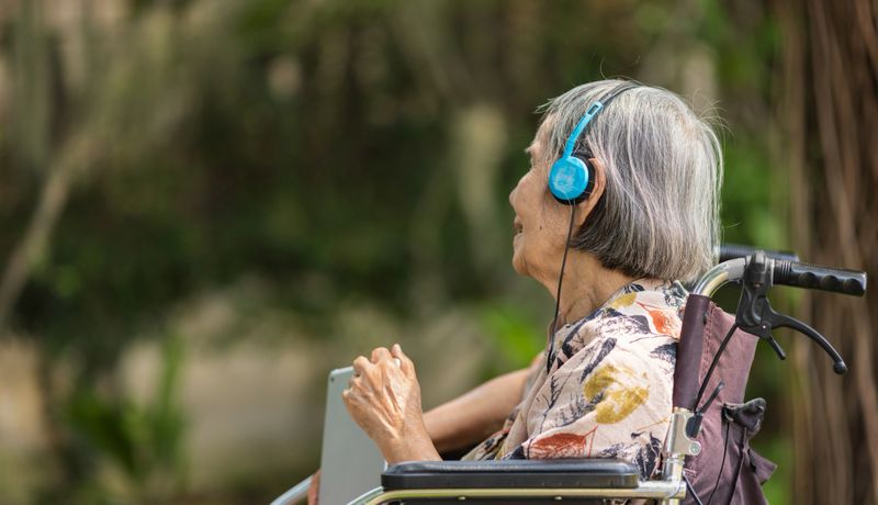 Music therapy in dementia treatment on elderly woman.