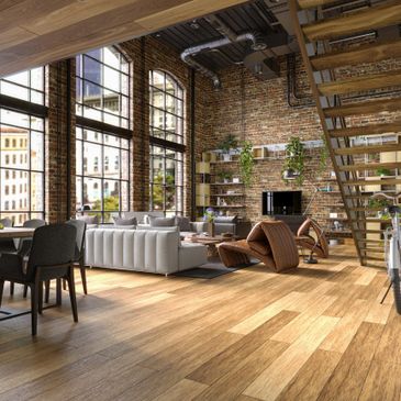 Spacious loft with exposed brick walls, large windows, and modern furniture.