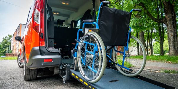 Wheelchair on a ramp leading into a vehicle for accessibility.