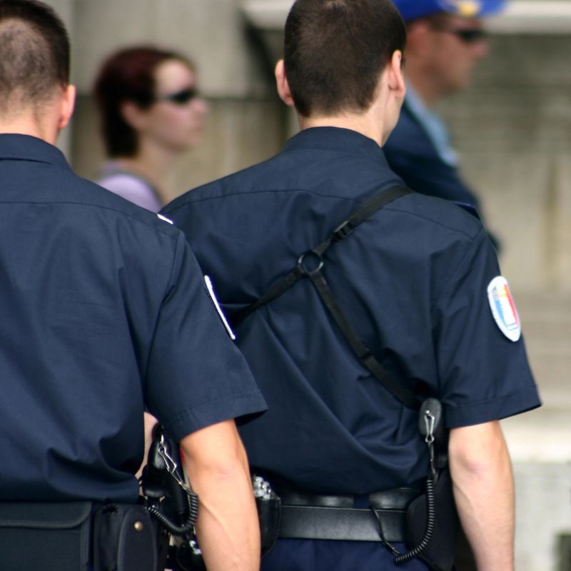 policemen walking nearby notredame in paris