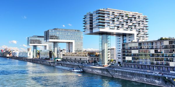 Modern buildings by the river on a clear day.