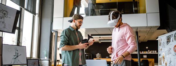 Person using augmented reality interface with floating app icons in a modern workspace.