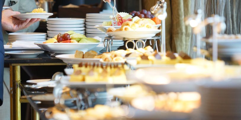 Buffet table with pastries and fruits.