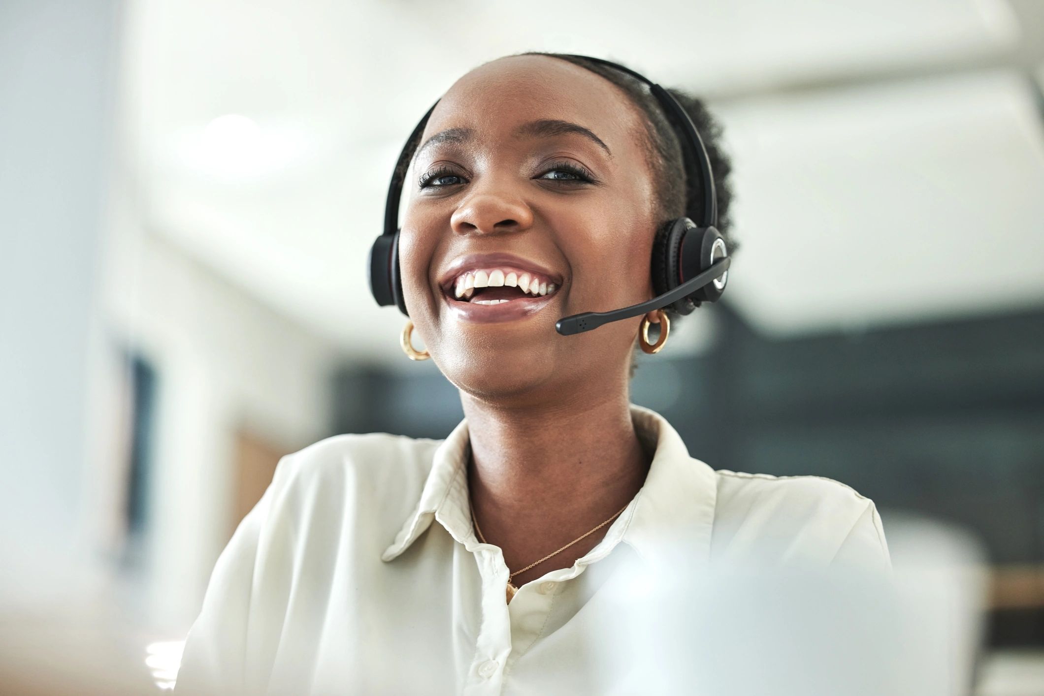 Smiling customer service representative wearing a headset.