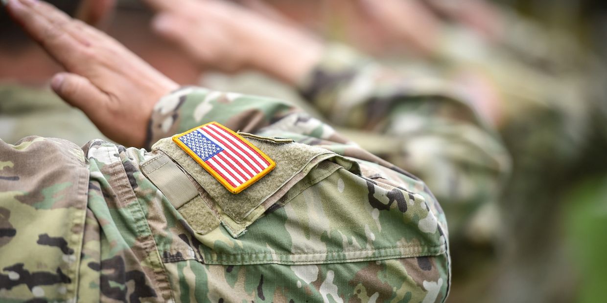 American soldiers saluting in uniform.