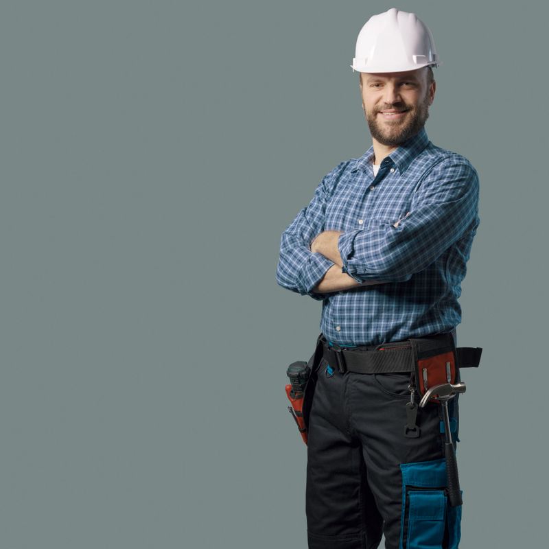 Smiling engineer with safety helmet, home renovation and professional service concept