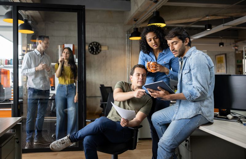 Group of Latin American workers working at a creative office - new business concepts