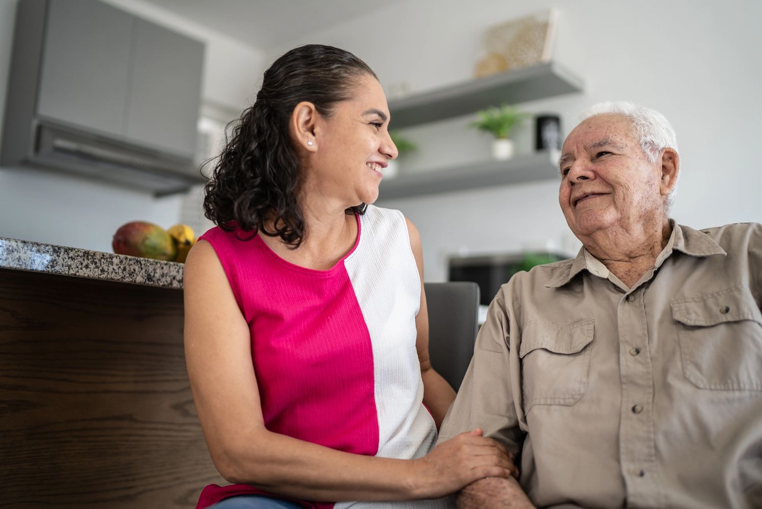 A woman and an old man sitting on the couch