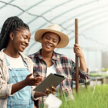 Decorative image: Two people standing in a greenhouse looking at a clipboard