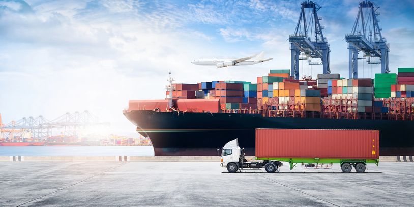 Plane, container, truck and container ship seen together