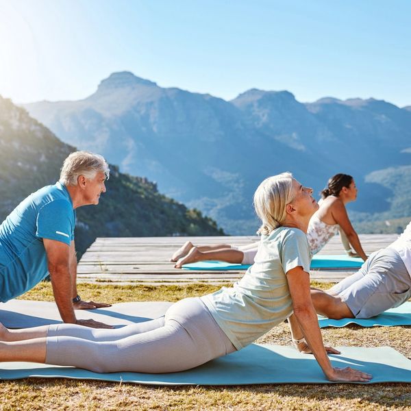 A group of people doing yoga in the mountains
