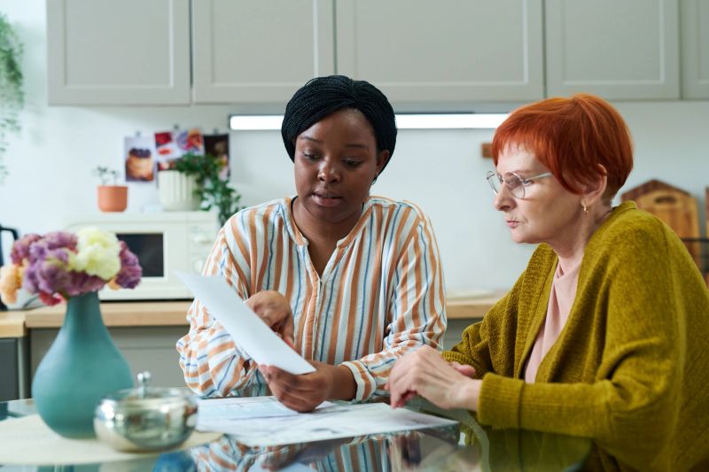 A healthcare navigator helping a resident enroll in Medicaid coverage at a community office.