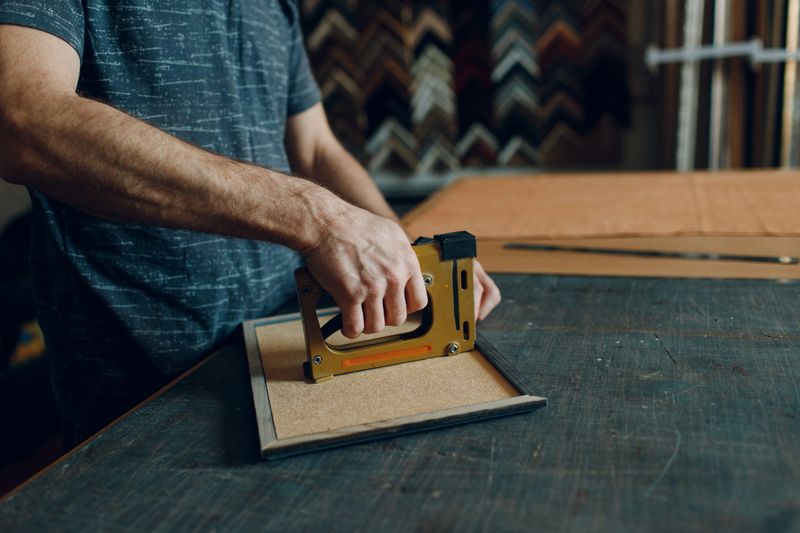 Framing Workshop. Making assembly stapler brackets baguette handmade picture frame at studio.