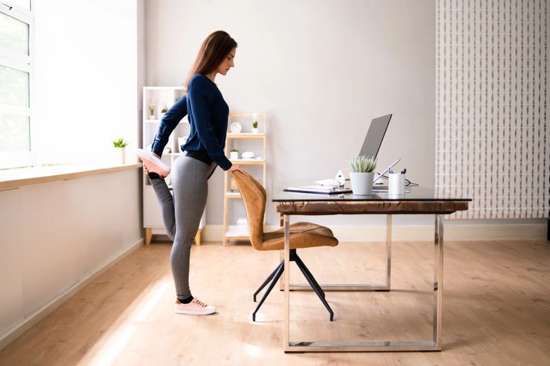 Young Businesswoman Looking At Invoice On Computer Doing Yoga