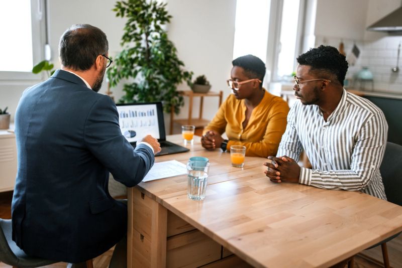 Young couple on a meeting with financial advisor at this home office