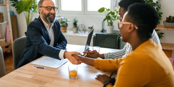 Two people shaking hands at a business meeting.