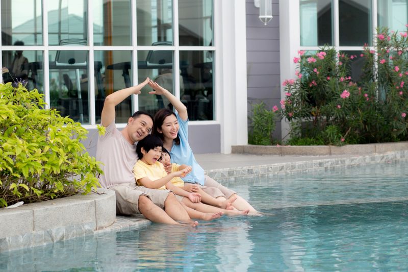 Happiness family relaxation at poolside in the home with enjoyment together, summer holiday, father and mother and children leisure at swimming pool with happy, relationship and bonding.