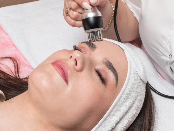 Woman receiving a facial skin treatment.