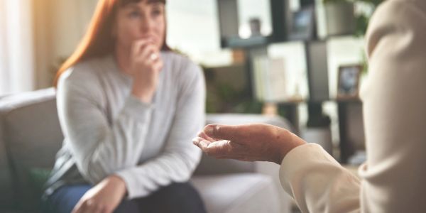 Woman receiving therapy support from a counselor.