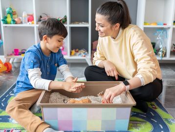 a play therapist engaging in play with a child