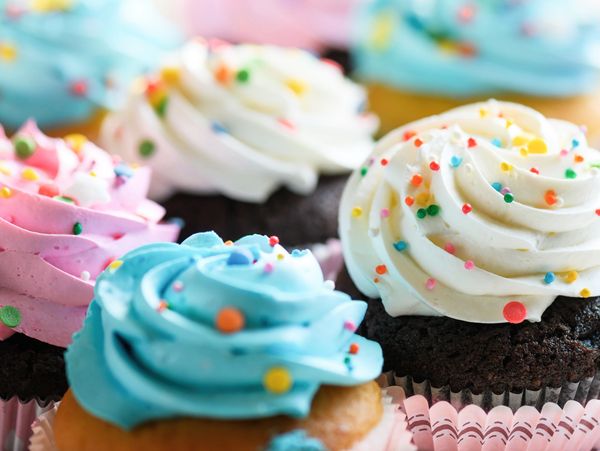 Colorful cupcakes with swirled frosting and sprinkles.