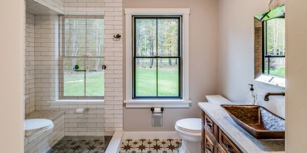 Bright bathroom with large window and walk-in shower.