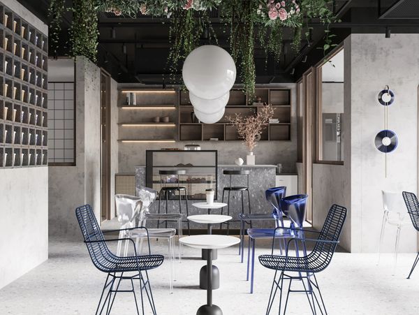 Modern cafe interior with hanging plants, stylish chairs, and a sleek counter.