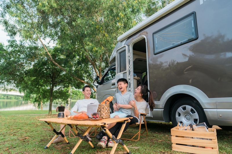 Family on vacation, they parked their motor home at a national park campground for the day. family having fun at recreation park
