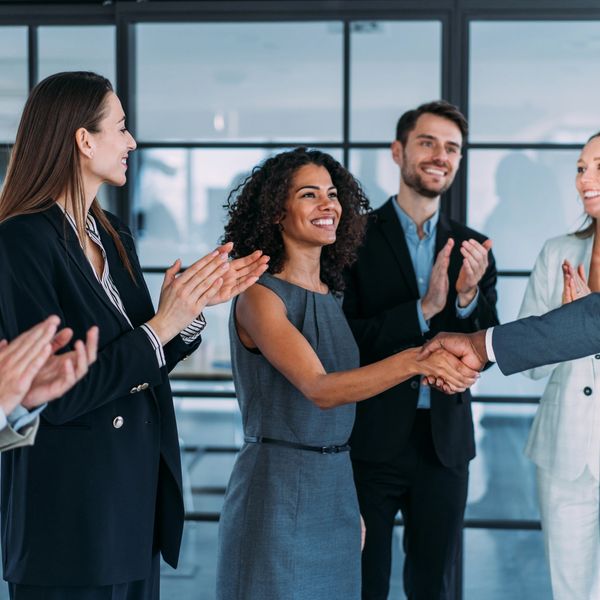 Smiling team congratulating success
