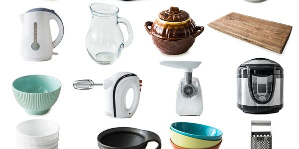 Assortment of kitchen tools and cookware including bowls, a kettle, and a food processor.