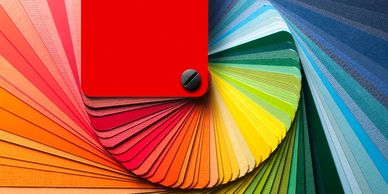 Fan of colorful paper swatches arranged in a gradient.
