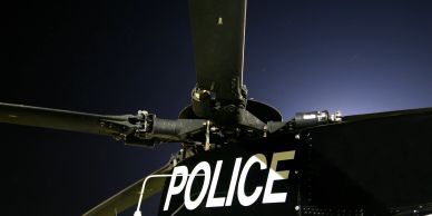 Close-up of a police helicopter rotor blade at night.