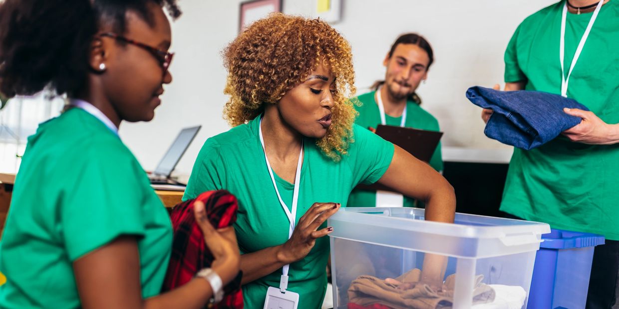 Volunteers sorting clothes for donation in a community center.
